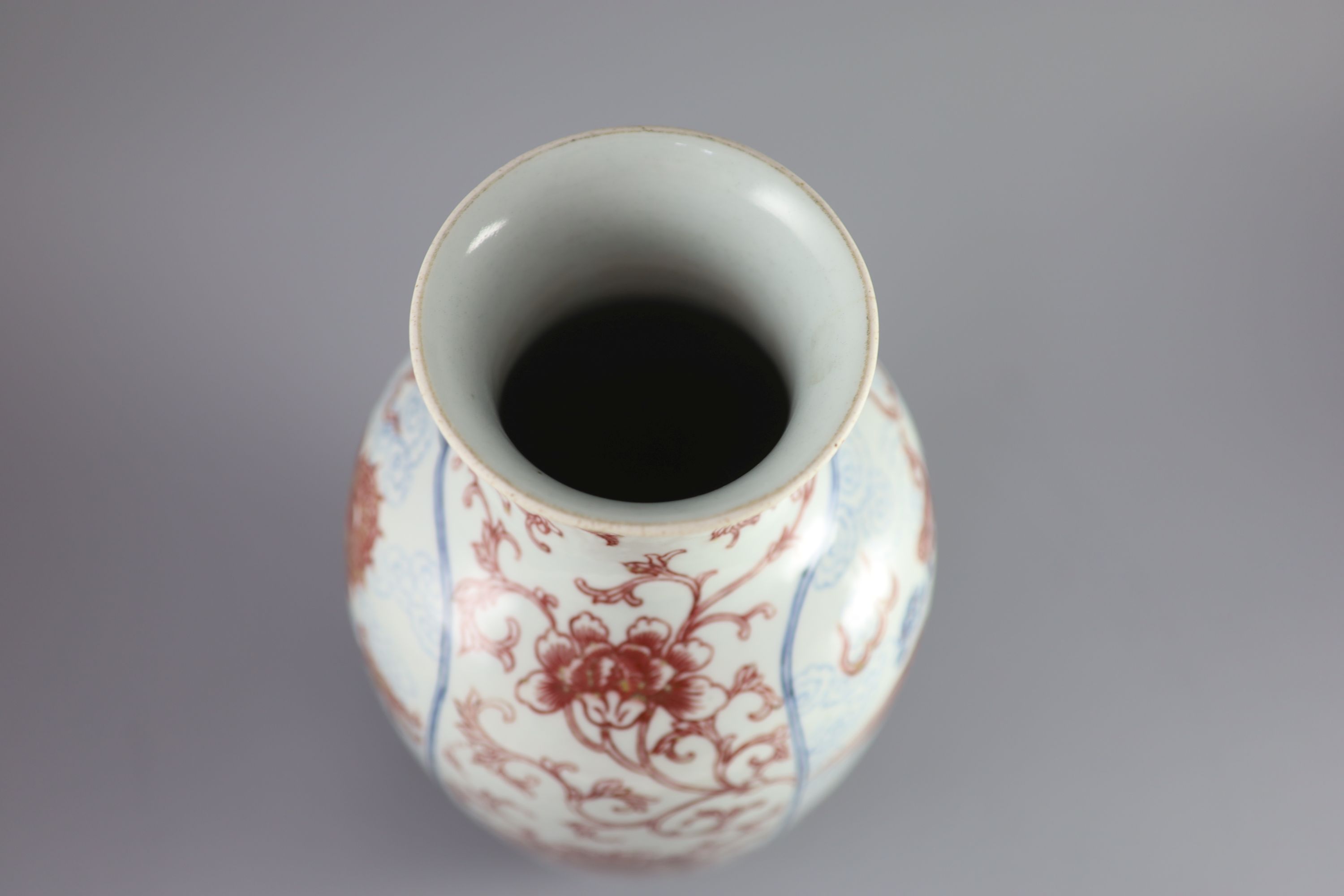 A Chinese underglaze blue and copper red 'dragon and phoenix' vase, Daoguang period (1821-50), 36cm high, rim ground off